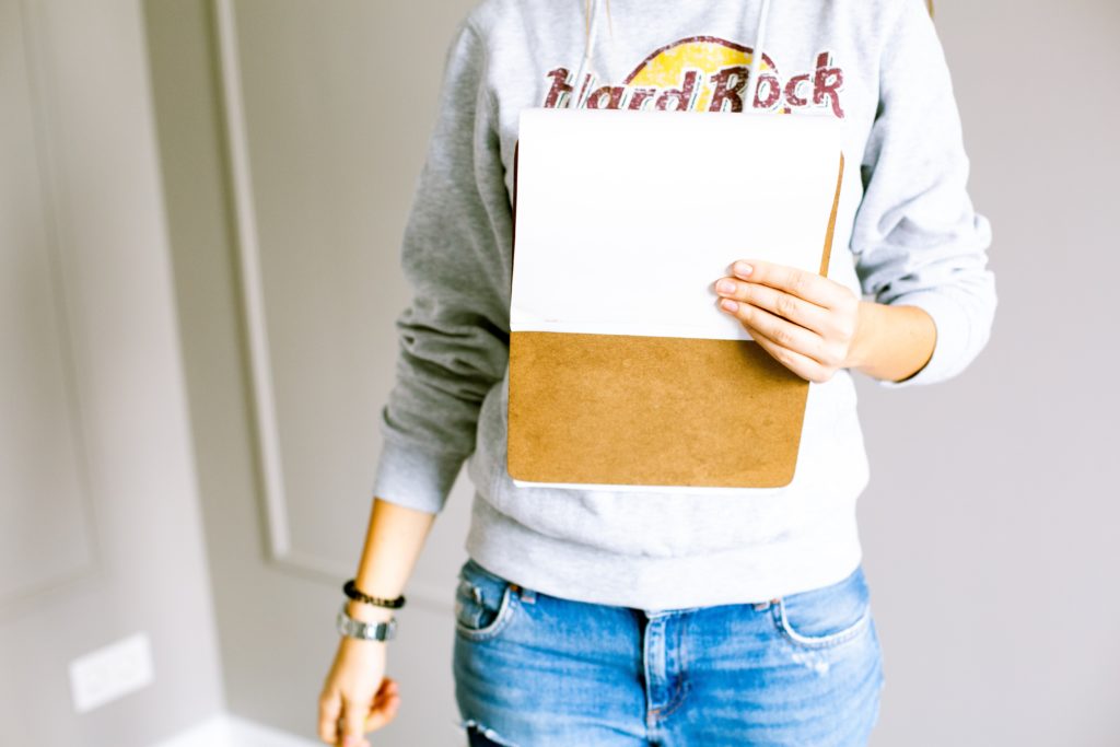 Woman Jeans Sweater Clipboard making notes at a home